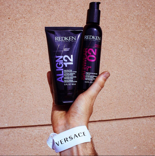 Redken Align 12 och Satinwear 02 som hålls upp av en hand
